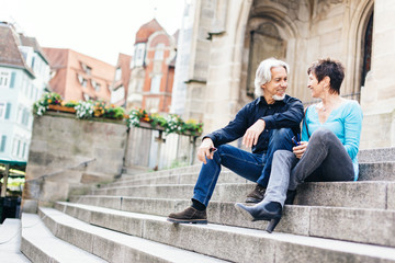Fototapeta na wymiar Senior Couple Taking A Rest Next To Church