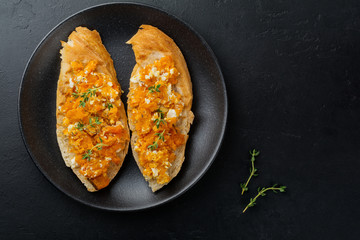 Bruschetta with baked pumpkin, feta cheese and thyme on  gray stone or concrete background. Spicy pumpkin sandwich. Selective focus. Top view.