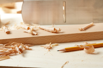 DIY concept. Woodworking and crafts. Chisel. plane and stock on the workbench. Top view. Wooden background.