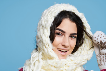 beautiful woman with a white scarf on her head, portrait, light blue background, new year, christmas, holiday, winter