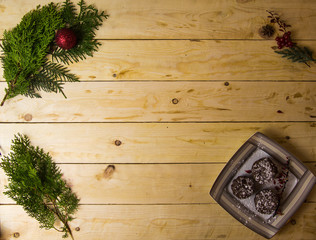 Three chocolate cupcakes with tea on a white tableware of a Christmas table
