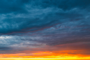 Naklejka na ściany i meble dramatic vibrant colorful clouds during sunset