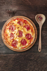 Pepperoni pizza with peppercorns and copy space