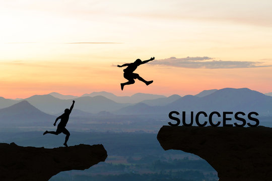 Men jump over silhouette failure commitment to success