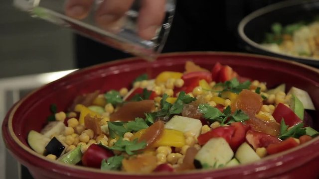 The Cook adds water in the dish