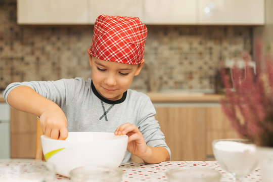 Boy mixing ingredients in a bowl while cooking