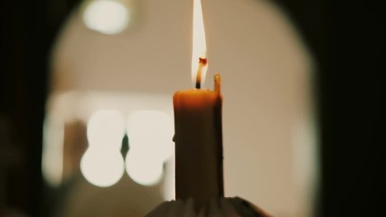 Closeup candle in an Orthodox church. Slow motion
