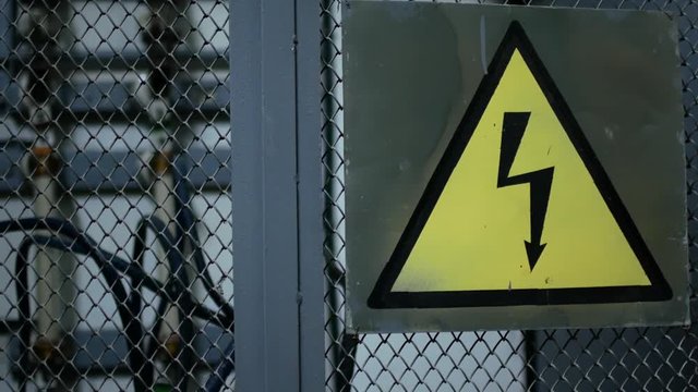 Warning sign on the danger of electricity. Sign on the fence of the power plant