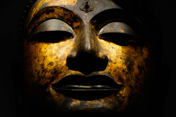 Buddha Face with Gorgeous Smile in Gold Color on Black Background