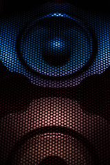 Abstract background. Speaker grill and subwoofer.
