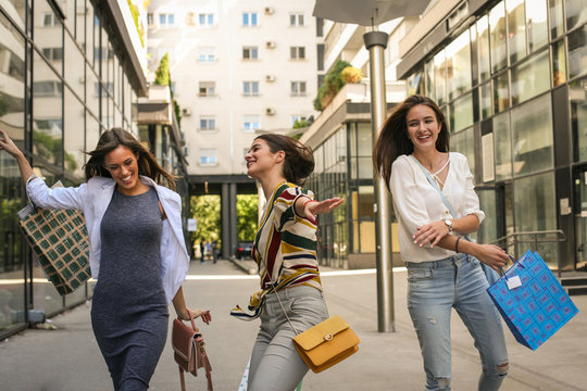 Women after shopping strolling city streets. Have fun.
