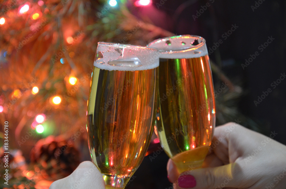 Wall mural christmas party drinking concept, glass of champagne with gift box on bokeh background