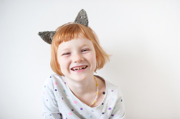 Red-haired girl with cat's ears on her head