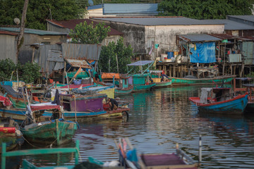 Fototapeta na wymiar Phu Quoc island Vietnam, December 2017 Boats are mooring next to fishermen houses