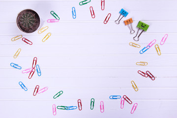 Business concept as a group of paperclip on canvas with one individual in the opposite direction.