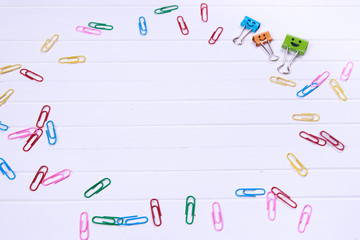 Business concept as a group of paperclip on canvas with one individual in the opposite direction.