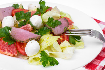 fresh vegetable salad with ham and mozzarella