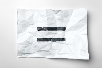 Equal sign on a crumpled paper
