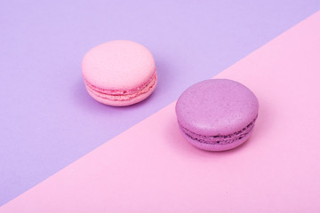 Small French macaroons on pastel background