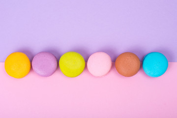 Small French macaroons on pastel background