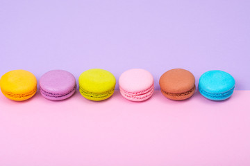 Small French macaroons on pastel background