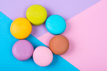 Fototapeta na wymiar Small French macaroons on pastel background