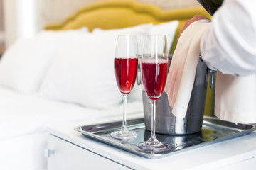 Honeymoon concept. Champagne bucket near bed in a hotel room