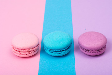 Small French macaroons on pastel background