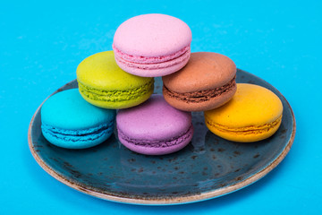 Small French macaroons on pastel background