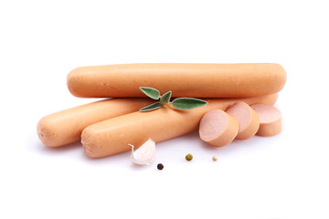 Frankfurter sausage isolated on white background with herbs and peppercorns