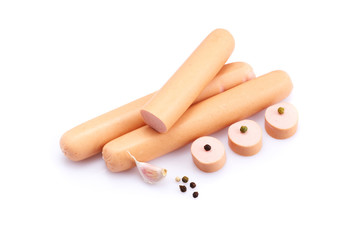 Frankfurter sausage isolated on white background with herbs and peppercorns