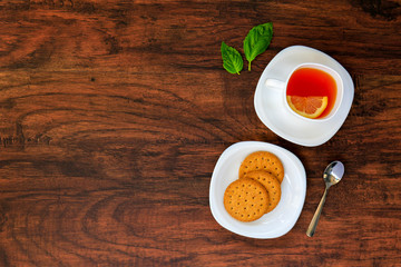 Top view of Cup of tea with Dry cracker cookies