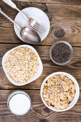 Oat flakes in white bowl for cooking