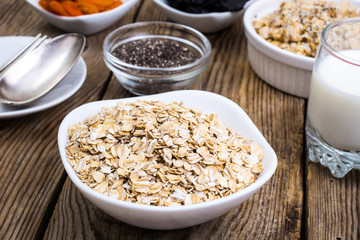 Oat flakes in white bowl for cooking