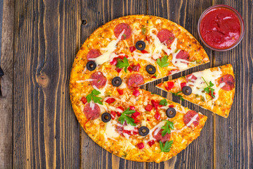 Homemade pizza with salami, mushrooms and cheese