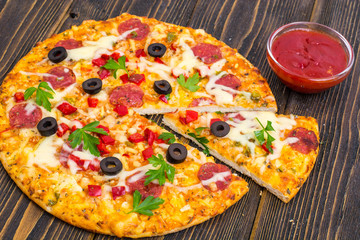 Homemade pizza with salami, mushrooms and cheese