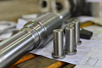 metal industry. finishing shaft surface on grinder machine