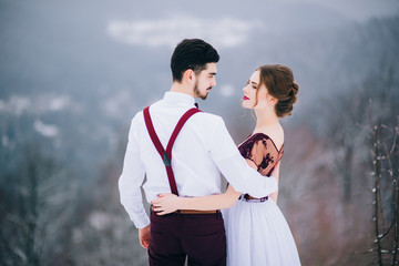 walk the groom and the bride in the Carpathian mountains