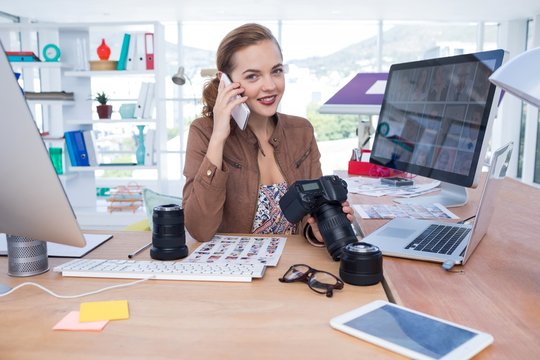 Female executive talking on mobile phone in office