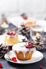 Christmas mini cake with sugar icing, cranberries and rosemary