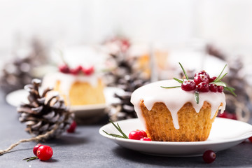 Christmas mini cake with sugar icing, cranberries and rosemary