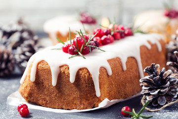 Christmas cake with sugar icing, cranberries and rosemary