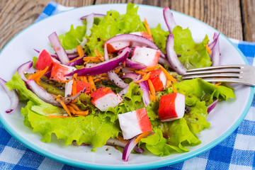 Delicious vegetable salad with crab sticks