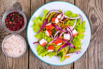 Delicious vegetable salad with crab sticks