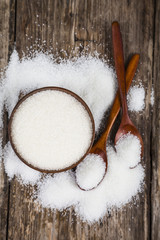 Bowl with sugar and a wooden spoons