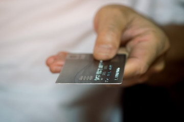 Male hand showing and holding credit card