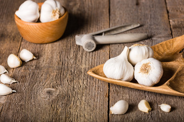 Garlic, Garlic cloves and Garlic bulb in vintage handmade wooden bowl.