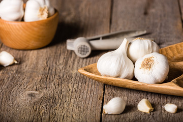 Garlic, Garlic cloves and Garlic bulb in vintage handmade wooden bowl.