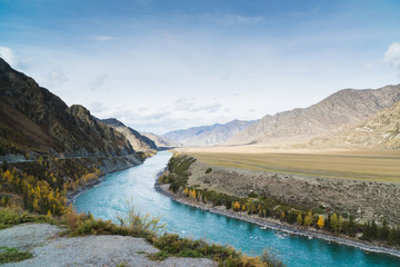 Mountainous summer landscape with a turquoise river.