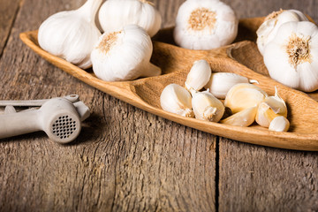 Garlic, Garlic cloves and Garlic bulb in vintage handmade wooden bowl.